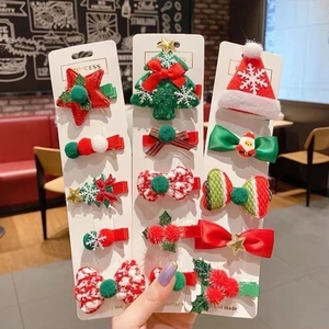 Handmade Christmas hair clip set with festive trees, stars and bows on display cards