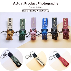 Detailed view of colorful cartoon French Bulldog keychains with matching PU leather wristlets