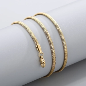 Detailed view of the gold snake chain necklace with a lobster clasp on a display stand