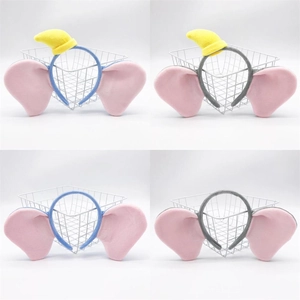 Detail of plush elephant ear headbands in blue and grey with small yellow hats