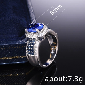 Elegant 8mm blue sapphire oval ring with sparkling rhinestones in a luxury jewelry box