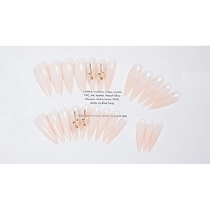 Nude pink stiletto press-on nails with 3D gold metal accents and translucent finish