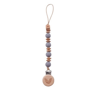 Detail of baby pacifier clip with beech wood beads and engraved rainbow and star motifs