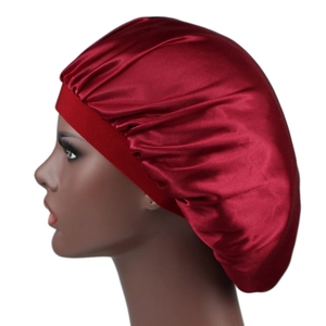 Burgundy silky satin bonnet sleep cap for hair protection shown on a model profile