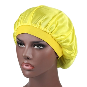 Detailed close-up of yellow silky satin bonnet featuring a wide elastic headband design