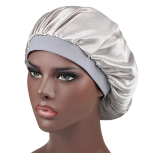 Side view of silver silky satin bonnet featuring a wide grey elastic band for hair care