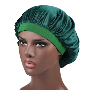 Detail of dark green silky satin bonnet featuring a wide elastic headband for hair protection