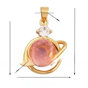 Detail view of 14x26mm gold-plated moon and star pendant with pink zircon inlay