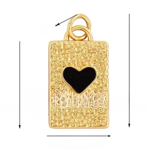 Detailed view of rectangle gold pendant with textured surface and black heart inlay