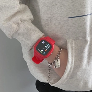 Close-up of a child wearing a red LED touch screen digital watch with silicone strap