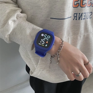 Close-up of blue square LED sports watch showing time and heart rate on child's wrist