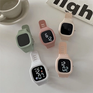 Flat lay of five minimalist square LED watches with colorful silicone straps and soft lighting