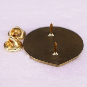 Back view of Thor's hammer brooch with bronze finish and two butterfly metal pin clutches