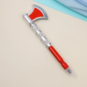 Detailed macro view of axe-shaped ballpoint pen with silver handle and red blade tip