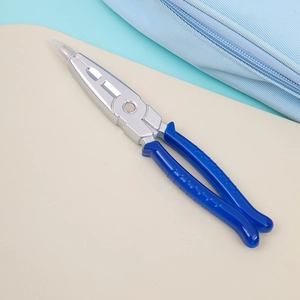 Detail of creative blue ballpoint pen designed in the shape of industrial needle-nose pliers