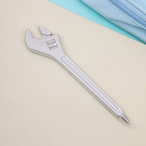 Detail of silver wrench-shaped ballpoint pen with transparent protective nib cap