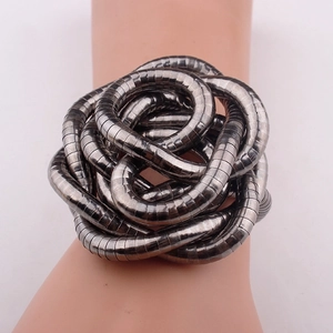Macro view of flexible snake bone chain necklace in gunmetal finish on a model wrist