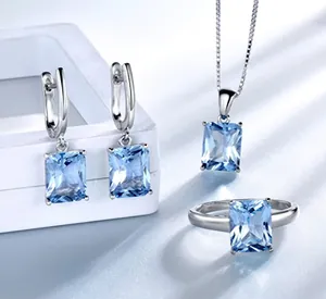 Macro detail of S925 sterling silver jewelry set with radiant cut blue gemstones