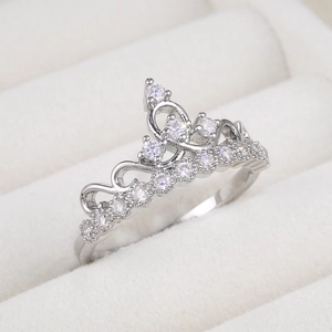 Exquisite silver-toned crown ring with micro-paved zircons shown from a 45-degree angle