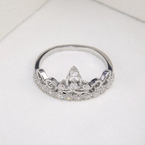 Macro shot of silver crown ring with pavé-set clear cubic zirconia crystals