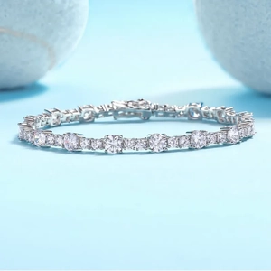 Elegant S925 sterling silver tennis bracelet with round cut moissanite stones on light blue background