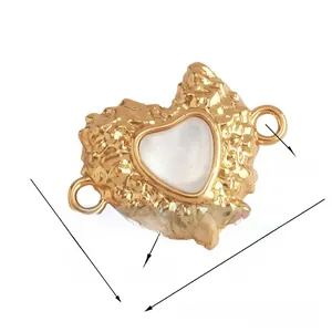 Detail of 19mm heart-shaped gold plated copper connector with hammered texture and shell inlay