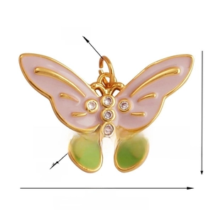 Detailed macro view of butterfly charm with pink and green enamel and zircon stones