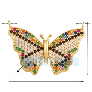 Detail of a brass butterfly pendant with colorful zircon stones and dual side rings