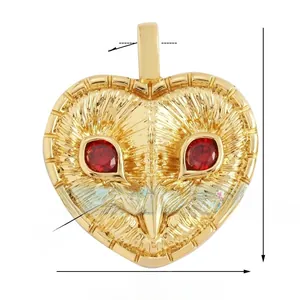 Macro detail of owl heart pendant with red zircon eyes and engraved feather texture