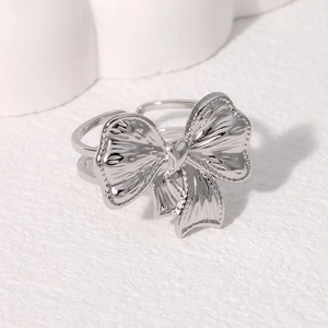 Minimalist silver bow knot open ring in stainless steel with elegant textured finish