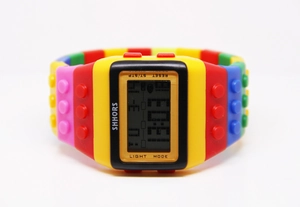 Macro shot of colorful building block watch strap with SHHORS digital interface display