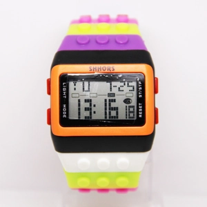 Macro detail of multi-color block watch featuring digital time, date, and week display