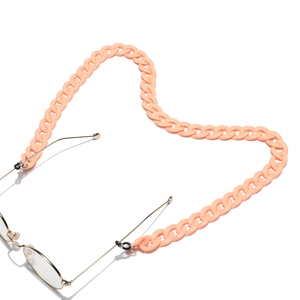 Detail of pink-orange acrylic glasses chain with black rubber loops and metal hooks