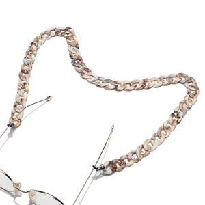 Detailed shot of amber tortoiseshell acrylic eyewear chain in a heart-shaped arrangement