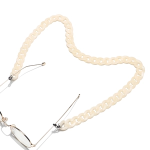 Detail of cream acrylic eyewear chain with silver loops and black silicone ends