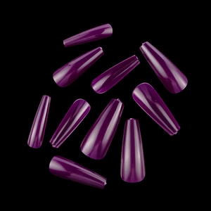 Macro view of glossy deep purple coffin press-on nails scattered on a black background