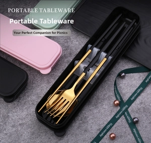 Close-up of stainless steel cutlery set with portable storage boxes on stone background