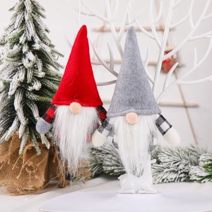 Nordic Christmas gnome plush ornaments in red and grey hanging on a white decorative branch