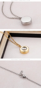Detail of round solitaire pendant necklaces in silver and gold with S-STEEL clasp