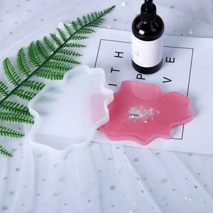 Close-up of irregular wave silicone mold for DIY resin coasters with pink finished sample