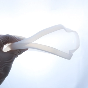 Flexible translucent silicone resin mold being bent to demonstrate material elasticity