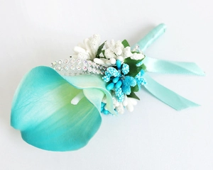 Detailed view of handmade blue Calla Lily boutonniere with crystal chain and ribbon