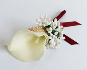 Detail of white PU calla lily boutonniere with gold diamond trim and burgundy ribbon