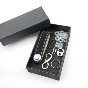 Detailed view of black leather key organizer set with metal hardware in a black gift box