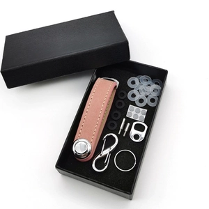 Pink leather key organizer set with accessories and carabiner in a black gift box