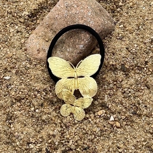 Golden butterfly metal hair tie with high elastic black band and intricate wing detail