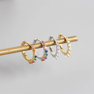 Close-up of S925 sterling silver earrings with rows of sparkling colorful zircons
