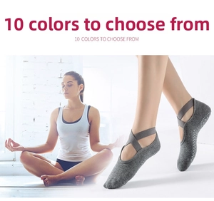 Detail of grey cotton yoga socks with elastic cross straps and anti-slip dots on sole
