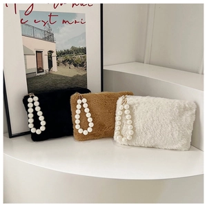 Detailed view of plush faux fur handbags in three colors with elegant pearl handles