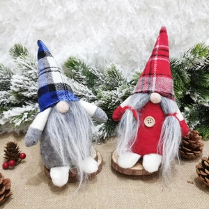 Nordic Christmas gnome plush dolls in red and blue plaid hats on wooden base